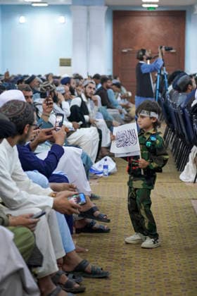 Taliban Fifth Anniversary Official Ceremony Kabul Afghanistan A child in a military uniform holds a Taliban flag in front of seated Taliban members during a ceremony at the Loya Jirga Tent marking the fifth anniversary of the Taliban™s return to power in Kabul, Afghanistan, on August 15, 2026. The event commemorates the government s takeover following the withdrawal of United States forces. Kabul Kabul Afghanistan Copyright: xJavidxAshnax