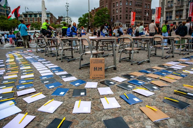 August 15, 2026, Amsterdam, Netherlands: A placard asking for freedom for the Afghan girls is surrounded by empty desks during the rally. On the fifth anniversary of the Taliban™s capture of Kabul, in Afghanistan, several organizations held a demonstration to demand that the Netherlands and the EU stop legitimizing the Taliban and prioritize the rights of Afghan women. Under the Taliban, girls are barred from education beyond primary school, and women are banned from many jobs. There are laws dictating that women must cover their faces in public and forbidding them from entering public parks. Human rights groups call it gender apartheid. Amsterdam Netherlands - ZUMAs197 20260815_aaa_s197_136 Copyright: xAnaxFernandezx