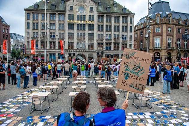 August 15, 2026, Amsterdam, Netherlands: Two women are keeping an eye on the chairs and empty desks representing the Afghan girls who have not been allowed to go to school. On the fifth anniversary of the Taliban™s capture of Kabul, in Afghanistan, several organizations held a demonstration to demand that the Netherlands and the EU stop legitimizing the Taliban and prioritize the rights of Afghan women. Under the Taliban, girls are barred from education beyond primary school, and women are banned from many jobs. There are laws dictating that women must cover their faces in public and forbidding them from entering public parks. Human rights groups call it gender apartheid. Amsterdam Netherlands  - ZUMAs197 20260815_aaa_s197_138 Copyright: xAnaxFernandezx