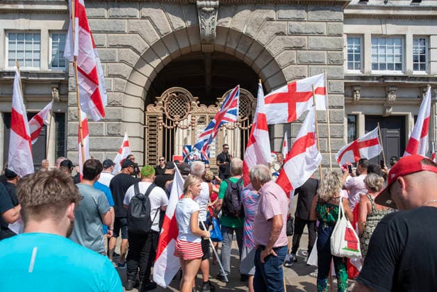 Britain First demo in Maidstone, UK - 15 Aug 2026 Far-right protesters hold flags and listen speeches outside the County Hall during a demonstration. Around 150 supporters of the Britain First far-right party gathered in Maidstone, UK. The protesters marched through at the town centre led by Paul Golding the current leader of the party. Far-right campaigners were confronted by a group of anti-fascist counter-protesters on the way to the County Hall. Maidstone United Kingdom Copyright: xKrisztianxElekx xSOPAxImagesx SSS_20260815_COUNTER_PROTEST_0011005017