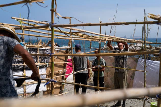 (260815) -- CEUTA, Aug. 15, 2026 -- Irregular migrants build makeshift shelters in Ceuta, Spain, Aug. 15, 2026. More than 72,000 migrants crossed irregularly into Ceuta from neighboring Morocco on July 30 and 31, according to the Spanish government. Most returned to Morocco later, while thousands remain in the enclave.Security was also tightened along the border ahead of Saturday after calls for another mass crossing circulated on social media. Moroccan security forces intercepted hundreds of migrants attempting to reach the border area, while Ceuta reported no influx on a scale comparable to that seen in late July. ) SPAIN-CEUTA-VIEW MengxDingbo 