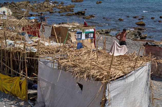 (260815) -- CEUTA, Aug. 15, 2026 -- Makeshift shelters are seen on Trampolin Beach in Ceuta, Spain, Aug. 15, 2026. More than 72,000 migrants crossed irregularly into Ceuta from neighboring Morocco on July 30 and 31, according to the Spanish government. Most returned to Morocco later, while thousands remain in the enclave.Security was also tightened along the border ahead of Saturday after calls for another mass crossing circulated on social media. Moroccan security forces intercepted hundreds of migrants attempting to reach the border area, while Ceuta reported no influx on a scale comparable to that seen in late July. ) SPAIN-CEUTA-VIEW MengxDingbo 