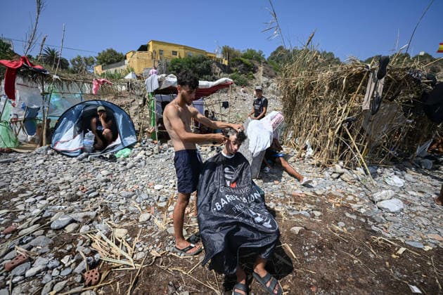 (260815) -- CEUTA, Aug. 15, 2026 -- Irregular migrants are seen in Ceuta, Spain, Aug. 15, 2026. More than 72,000 migrants crossed irregularly into Ceuta from neighboring Morocco on July 30 and 31, according to the Spanish government. Most returned to Morocco later, while thousands remain in the enclave.Security was also tightened along the border ahead of Saturday after calls for another mass crossing circulated on social media. Moroccan security forces intercepted hundreds of migrants attempting to reach the border area, while Ceuta reported no influx on a scale comparable to that seen in late July. ) SPAIN-CEUTA-VIEW ChengxMin 