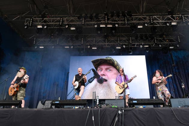August 15, 2026, Williamscot, Oxfordshire, United Kingdom: l-r Jake Byers, Richard Collins, John Wheeler and Hippy Joe Hymas with American rockgrass band Hayseed Dixie, performing live on stage at Fairport s Cropredy Convention. Formed in Nashville, Tennessee, in 2000,Hayseed Dixie is an American band that quoined the term rockgrass, which is hard rock and heavy metal songs played on traditional bluegrass instruments with. Their name is a parody of heavy metal band AC DC. The band consists of John Wheeler Barley Scotch on vocals, guitars, fiddle, keyboards, Hippy Joe Hymas on mandolin, acoustic guitar, vocals Jake Byers on bass, vocals Richard Collins on Banjo and vocals. Williamscot United Kingdom - ZUMAs197 20260815_aaa_s197_181 Copyright: xDawnxFletcher-Parkx