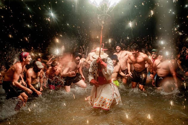 August 15, 2026, Badalona, Spain: People react as a Correfoc devil enters the sea during the August Festival in Badalona, north of Barcelona. The Correfoc, a traditional Catalan celebration featuring fireworks and fire-spitting performers, ends in the waters of Badalona beach. Badalona Spain  - ZUMAb137 20260815_fap_b137_001 Copyright: xJordixBoixareux