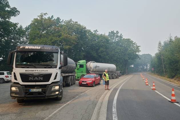 A road open only for trucks bringing water from the Robertville lake a fire rages in the Hautes Fagnes (High Fens) nature reserve, on Sunday 16 August 2026 in Robertville. The fire started on August 14th and 2700 hectares (on a total of 4500) are impacted.  NICOLASxLAMBERT 183509387