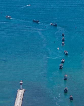 (260816) -- QIONGHAI, Aug. 16, 2026 -- An aerial drone photo taken on Aug. 16, 2026 shows fishing boats departing for fishing from Tanmen port in Qionghai, south China s Hainan Province. The fishing season of the South China Sea kicked off at noon on Sunday after this summer s three-and-a-half-month fishing ban. ) CHINA-SOUTH CHINA SEA-FISHING SEASON-KICK OFF (CN) PuxXiaoxu 