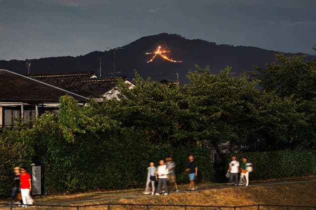 General view, August 16, 2026 - The Kyoto Gozan Okuribi or Five Mountain Bonfires, illuminate the night sky over Kyoto, Japan. The traditional summer observance marks the end of the Obon season, as five mountains surrounding the city are lit with bonfires to send ancestral spirits back to the afterlife.  aflo_341148128