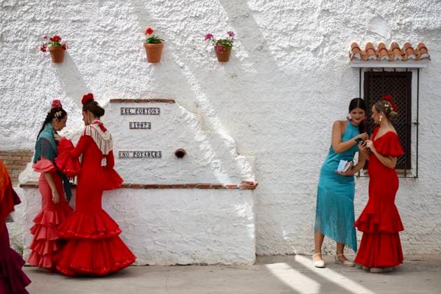 Scenes from the Málaga Fair: Several women dressed in flamenco gowns stroll through the Cortijo de Torres at the Málaga Fair. August 16, 2026, in Málaga, Andalusia, Spain. Locals and visitors enjoy the Málaga Fair at the fairgrounds. August 16, 2026, in Málaga, Andalusia, Málaga, Andalusia, Spain  Copyright: xÃlexxZeax 7716795