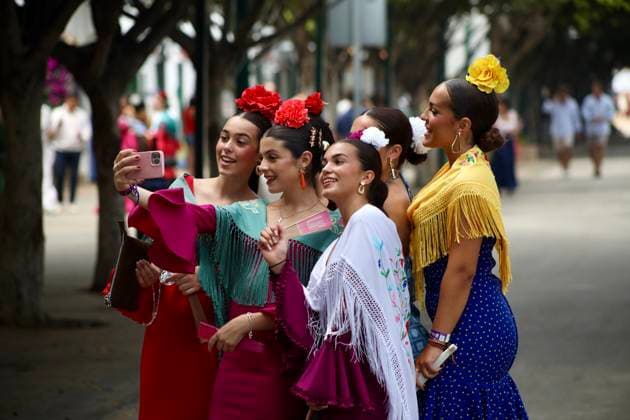 Scenes from the Málaga Fair: Several women dressed in flamenco gowns stroll through the Cortijo de Torres at the Málaga Fair. August 16, 2026, in Málaga, Andalusia, Spain. Locals and visitors enjoy the Málaga Fair at the fairgrounds. August 16, 2026, in Málaga, Andalusia, Málaga, Andalusia, Spain  Copyright: xÃlexxZeax 7716797