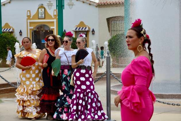 Scenes from the Málaga Fair: Several women dressed in flamenco gowns stroll through the Cortijo de Torres at the Málaga Fair. August 16, 2026, in Málaga, Andalusia, Spain. Locals and visitors enjoy the Málaga Fair at the fairgrounds. August 16, 2026, in Málaga, Andalusia, Málaga, Andalusia, Spain  Copyright: xÃlexxZeax 7716792