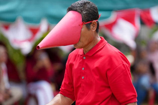 August 16, 2026, Banda Aceh, Aceh, Indonesia: Residents enthusiastically competed to gather balls while wearing paper-cone masks during a series of games held to celebrate Indonesia s 81st Independence Day in Banda Aceh, Aceh Province, Indonesia, on Sunday. This traditional contest, which restricts the participants field of vision, was organized by residents to foster a sense of togetherness and entertain the local community in celebration of Independence Day. Banda Aceh Indonesia - ZUMAi115 20260816_zip_i115_008 Copyright: xMuhammadxIqbalx
