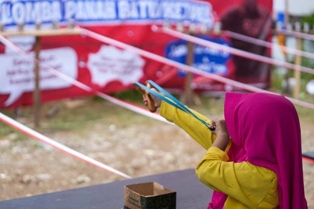 August 16, 2026, Banda Aceh, Aceh, Indonesia: A young girl was seen aiming at a target during a slingshot competition held to celebrate Indonesia s 81st Independence Day in Banda Aceh, Aceh Province, Indonesia, on Sunday. Residents organized various traditional competitions to foster a sense of togetherness and entertain the local community in celebration of Independence Day. Banda Aceh Indonesia - ZUMAi115 20260816_zip_i115_012 Copyright: xMuhammadxIqbalx