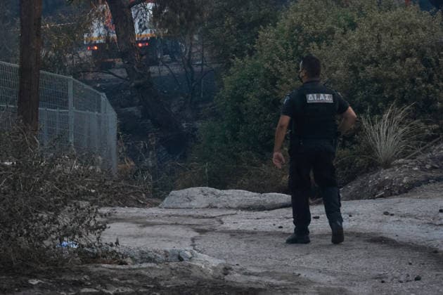 Wildfire kills 2 on Greek island of Salamina near Athens ATHENS, GREECE - AUGUST 16: (EDITOR S NOTE: Image depicts death) Police officers stand guard near the area where two bodies were found, during a wildfire, on the island of Salamina, west of Athens, Greece, on August 16, 2026 Costas Baltas Anadolu Athens Greece. Editorial use only. Please get in touch for any other usage.  Copyright: x2026xAnadoluxCostasxBaltasx