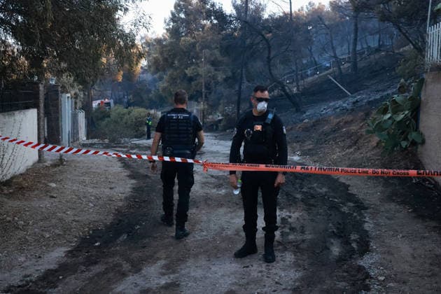 Wildfire kills 2 on Greek island of Salamina near Athens ATHENS, GREECE - AUGUST 16: Police officers stand guard near the area where two bodies were found, during a wildfire, on the island of Salamina, west of Athens, Greece, on August 16, 2026 Costas Baltas Anadolu Athens Greece. Editorial use only. Please get in touch for any other usage.  Copyright: x2026xAnadoluxCostasxBaltasx