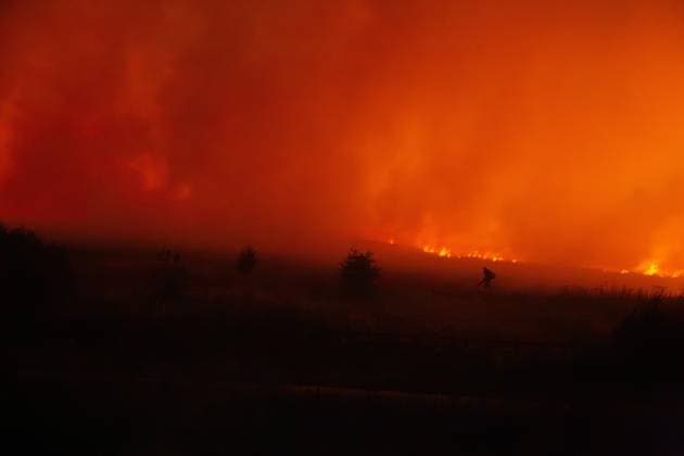 August 16, 2026, Merthyr Tydfil, GB: MERTHYR TYDFIL, WALES, UK, AUGUST 16, 2026: Firefighters from South Wales Fire and Rescue Service battle a wildfire near Dowlais Top as flames approach the Heads of the Valleys road in Merthyr Tydfil, Wales. The wildfire comes after an extended period of hot and dry weather across the United Kingdom. Merthyr Tydfil GB  - ZUMAq101 20260816_zna_q101_079 Copyright: xEthanxFowlerx