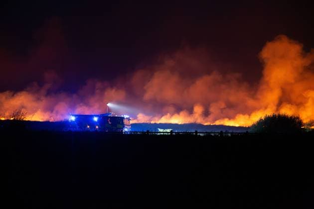 August 16, 2026, Merthyr Tydfil, GB: MERTHYR TYDFIL, WALES, UK, AUGUST 16, 2026: Firefighters from South Wales Fire and Rescue Service battle a wildfire near Dowlais Top as flames approach the Heads of the Valleys road in Merthyr Tydfil, Wales. The wildfire comes after an extended period of hot and dry weather across the United Kingdom. Merthyr Tydfil GB  - ZUMAq101 20260816_zna_q101_080 Copyright: xEthanxFowlerx