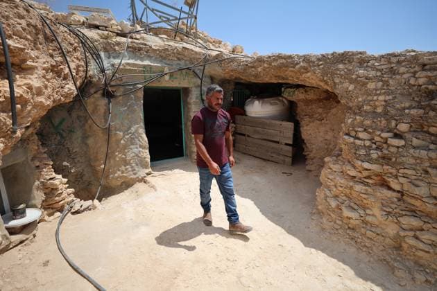 August 16, 2026, Masafer Yatta, Palestine, State of: MASAFER YATTA, WEST BANK, PALESTINE, AUGUST 16, 2026: Palestinian Abdullah Dababseh holds his phone displaying a demolition order issued by the Israeli army for the cave where he lives in Khirbet Khallet Al-Dabaa, south of Hebron. According to local residents, demolition orders were issued for three homes, three caves, a school, trees and crops in the area. Residents said the village was demolished in May 2025, forcing some Palestinians to live in caves. Masafer Yatta Palestine, State of - ZUMAq101 20260816_zna_q101_106 Copyright: xMosabxShawerx