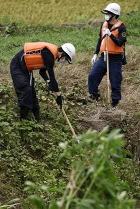 Aftermath of torrential rain in Chiba Police officers search for missing persons near a swollen river in Chiba near Tokyo on Aug. 15, 2026, following the torrential rain that hit the region on Aug. 13.  A14AA0005626010P