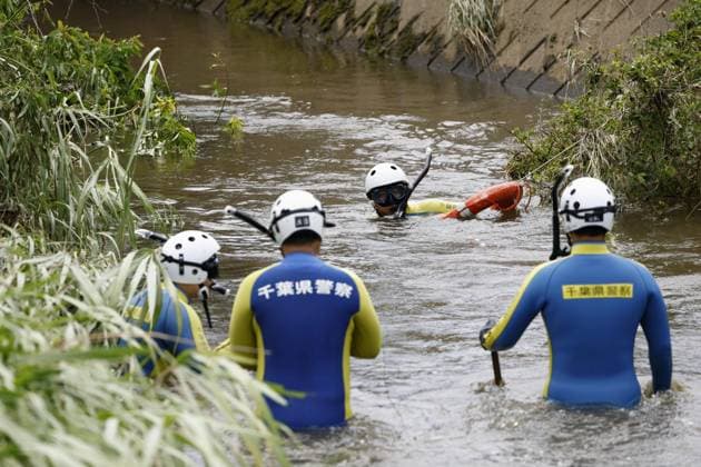 Aftermath of torrential rain in Chiba Police officers search for missing persons in a swollen river in Chiba near Tokyo on Aug. 15, 2026, following the torrential rain that hit the region on Aug. 13.  A14AA0005626011P