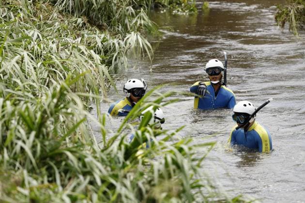Aftermath of torrential rain in Chiba Police officers search for missing persons in a swollen river in Chiba near Tokyo on Aug. 15, 2026, following the torrential rain that hit the region on Aug. 13.  A14AA0005626013P