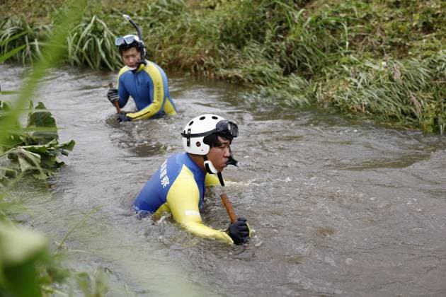 Aftermath of torrential rain in Chiba Police officers search for missing persons in a swollen river in Chiba near Tokyo on Aug. 15, 2026, following the torrential rain that hit the region on Aug. 13.  A14AA0005626014P