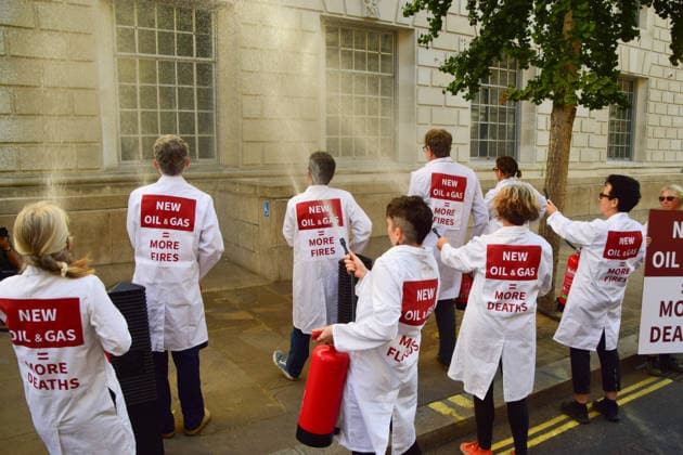 August 17, 2026, London, England, United Kingdom: Climate activists from the group Scientists On Survival spray the Department for Energy Security and Net Zero (DESNZ) in Westminster with water using fire extinguishers in protest against Rosebank, as the public consulation on the North Sea oil and gas field concludes. London United Kingdom - ZUMAv130 20260817_zip_v130_006 Copyright: xVukxValcicx