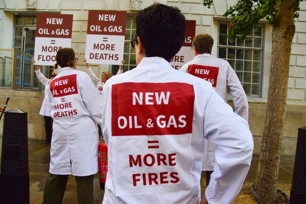 August 17, 2026, London, England, United Kingdom: Climate activists from the group Scientists On Survival stand outside the Department for Energy Security and Net Zero (DESNZ) in Westminster with placards and fire extinguishers after spraying the building with water in protest against Rosebank, as the public consulation on the North Sea oil and gas field concludes. London United Kingdom - ZUMAv130 20260817_zip_v130_007 Copyright: xVukxValcicx