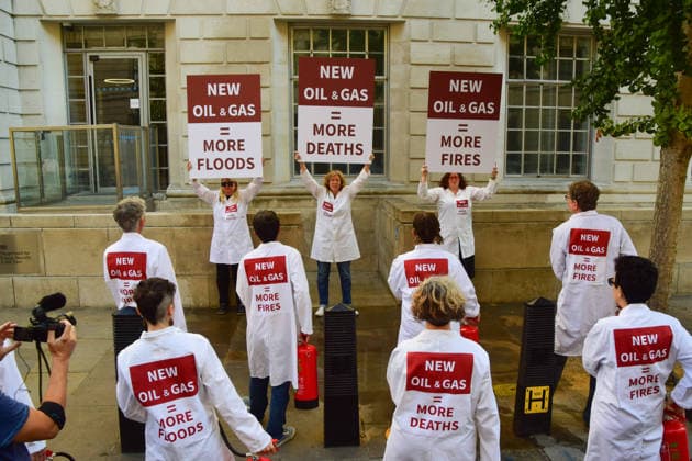 August 17, 2026, London, England, United Kingdom: Climate activists from the group Scientists On Survival stand outside the Department for Energy Security and Net Zero (DESNZ) in Westminster with placards and fire extinguishers after spraying the building with water in protest against Rosebank, as the public consulation on the North Sea oil and gas field concludes. London United Kingdom - ZUMAv130 20260817_zip_v130_009 Copyright: xVukxValcicx
