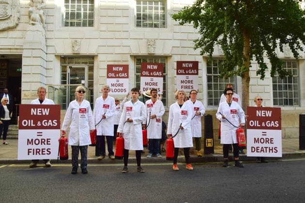 August 17, 2026, London, England, United Kingdom: Climate activists from the group Scientists On Survival stand outside the Department for Energy Security and Net Zero (DESNZ) in Westminster with placards and fire extinguishers after spraying the building with water in protest against Rosebank, as the public consulation on the North Sea oil and gas field concludes. London United Kingdom - ZUMAv130 20260817_zip_v130_011 Copyright: xVukxValcicx