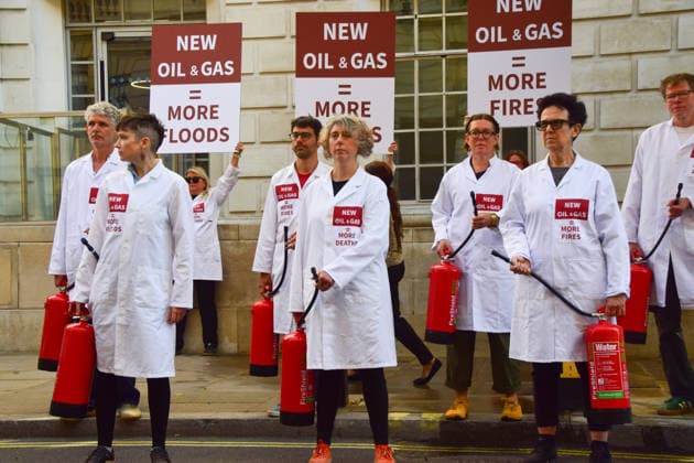 August 17, 2026, London, England, United Kingdom: Climate activists from the group Scientists On Survival stand outside the Department for Energy Security and Net Zero (DESNZ) in Westminster with placards and fire extinguishers after spraying the building with water in protest against Rosebank, as the public consulation on the North Sea oil and gas field concludes. London United Kingdom - ZUMAv130 20260817_zip_v130_015 Copyright: xVukxValcicx