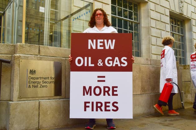 August 17, 2026, London, England, United Kingdom: A climate activist from the group Scientists On Survival stands outside the Department for Energy Security and Net Zero (DESNZ) in Westminster with a placard in protest against Rosebank, as the public consulation on the North Sea oil and gas field concludes. London United Kingdom - ZUMAv130 20260817_zip_v130_017 Copyright: xVukxValcicx