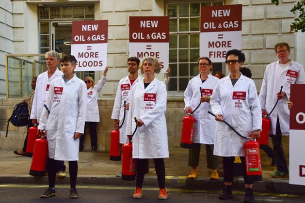 August 17, 2026, London, England, United Kingdom: Climate activists from the group Scientists On Survival stand outside the Department for Energy Security and Net Zero (DESNZ) in Westminster with placards and fire extinguishers after spraying the building with water in protest against Rosebank, as the public consulation on the North Sea oil and gas field concludes. London United Kingdom - ZUMAv130 20260817_zip_v130_023 Copyright: xVukxValcicx