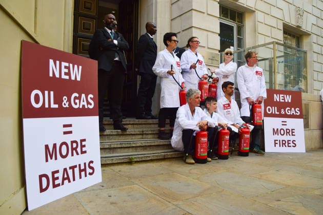 August 17, 2026, London, England, United Kingdom: Climate activists from the group Scientists On Survival sit outside the Department for Energy Security and Net Zero (DESNZ) in Westminster with fire extinguishers after spraying the building with water in protest against Rosebank, as the public consulation on the North Sea oil and gas field concludes. London United Kingdom - ZUMAv130 20260817_zip_v130_026 Copyright: xVukxValcicx