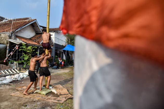 August 17, 2026, Bandung Regency, West Java, Indonesia: Participants climb a pole coated in oil and mud, with prizes placed at the top, during a competition locally known as Panjat Pinang to commemorate the 81st anniversary of the Republic of Indonesia s independence in Lengkong Village, Bandung Regency, Indonesia. Bandung Regency Indonesia - ZUMAr272 20260817_zip_r272_016 Copyright: xDimasxRachmatsyahx