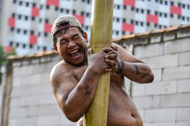 August 17, 2026, Bandung Regency, West Java, Indonesia: Participants climb a pole coated in oil and mud, with prizes placed at the top, during a competition locally known as Panjat Pinang to commemorate the 81st anniversary of the Republic of Indonesia s independence in Lengkong Village, Bandung Regency, Indonesia. Bandung Regency Indonesia - ZUMAr272 20260817_zip_r272_017 Copyright: xDimasxRachmatsyahx