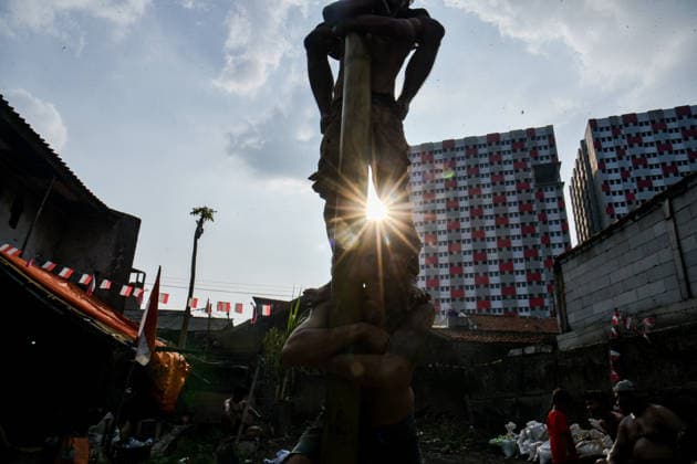 August 17, 2026, Bandung Regency, West Java, Indonesia: Participants climb a pole coated in oil and mud, with prizes placed at the top, during a competition locally known as Panjat Pinang to commemorate the 81st anniversary of the Republic of Indonesia s independence in Lengkong Village, Bandung Regency, Indonesia. Bandung Regency Indonesia - ZUMAr272 20260817_zip_r272_019 Copyright: xDimasxRachmatsyahx