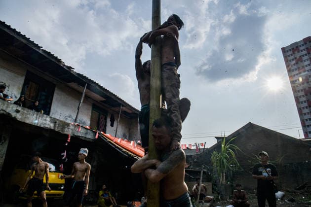 August 17, 2026, Bandung Regency, West Java, Indonesia: Participants climb a pole coated in oil and mud, with prizes placed at the top, during a competition locally known as Panjat Pinang to commemorate the 81st anniversary of the Republic of Indonesia s independence in Lengkong Village, Bandung Regency, Indonesia. Bandung Regency Indonesia - ZUMAr272 20260817_zip_r272_021 Copyright: xDimasxRachmatsyahx