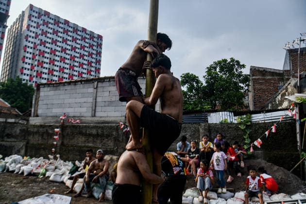 August 17, 2026, Bandung Regency, West Java, Indonesia: Participants climb a pole coated in oil and mud, with prizes placed at the top, during a competition locally known as Panjat Pinang to commemorate the 81st anniversary of the Republic of Indonesia s independence in Lengkong Village, Bandung Regency, Indonesia. Bandung Regency Indonesia - ZUMAr272 20260817_zip_r272_024 Copyright: xDimasxRachmatsyahx