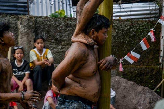 August 17, 2026, Bandung Regency, West Java, Indonesia: Participants climb a pole coated in oil and mud, with prizes placed at the top, during a competition locally known as Panjat Pinang to commemorate the 81st anniversary of the Republic of Indonesia s independence in Lengkong Village, Bandung Regency, Indonesia. Bandung Regency Indonesia - ZUMAr272 20260817_zip_r272_026 Copyright: xDimasxRachmatsyahx
