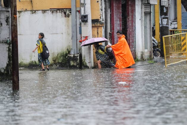 (260817) -- QUEZON CITY, Aug. 17, 2026 -- People wade through floodwater in Quezon City, the Philippines, on Aug. 17, 2026. The Philippine government has suspended in-person classes in Metro Manila and 12 other provinces as heavy rains from tropical cyclones and the southwest monsoon continue to batter the country, local media reported on Monday. The extreme rainfall has triggered severe flooding and landslides across the nation. The well-known flood-control corruption scandal has left key infrastructure unfinished or poorly maintained, further straining the country s disaster response, local media reported. ) THE PHILIPPINES-QUEZON CITY-SOUTHWEST MONSOON-FLOOD RouellexUmali 