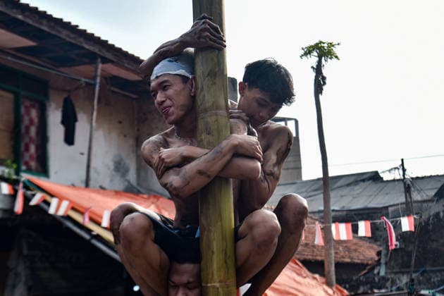 August 17, 2026, Bandung Regency, West Java, Indonesia: Participants climb a pole coated in oil and mud, with prizes placed at the top, during a competition locally known as Panjat Pinang to commemorate the 81st anniversary of the Republic of Indonesia s independence in Lengkong Village, Bandung Regency, Indonesia. Bandung Regency Indonesia - ZUMAr272 20260817_zip_r272_028 Copyright: xDimasxRachmatsyahx
