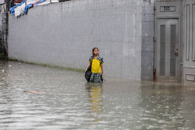 (260817) -- QUEZON CITY, Aug. 17, 2026 -- A student stands in floodwater in Quezon City, the Philippines, on Aug. 17, 2026. The Philippine government has suspended in-person classes in Metro Manila and 12 other provinces as heavy rains from tropical cyclones and the southwest monsoon continue to batter the country, local media reported on Monday. The extreme rainfall has triggered severe flooding and landslides across the nation. The well-known flood-control corruption scandal has left key infrastructure unfinished or poorly maintained, further straining the country s disaster response, local media reported. ) THE PHILIPPINES-QUEZON CITY-SOUTHWEST MONSOON-FLOOD RouellexUmali 