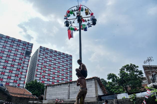 August 17, 2026, Bandung Regency, West Java, Indonesia: Participants climb a pole coated in oil and mud, with prizes placed at the top, during a competition locally known as Panjat Pinang to commemorate the 81st anniversary of the Republic of Indonesia s independence in Lengkong Village, Bandung Regency, Indonesia. Bandung Regency Indonesia  - ZUMAr272 20260817_zip_r272_029 Copyright: xDimasxRachmatsyahx