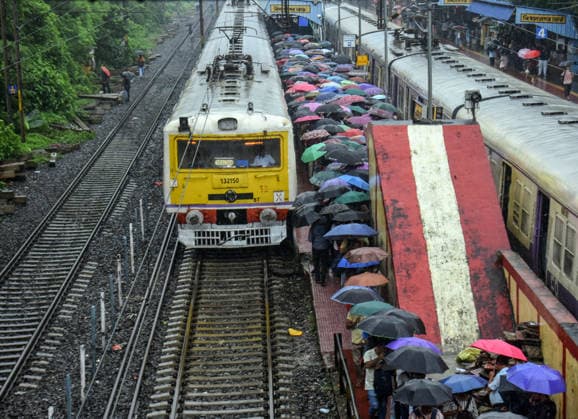 RECORD DATE NOT STATED Commuters Use Umbrellas Amid Heavy Rainfall at Kolkata Railway Station Kolkata West Bengal , Aug 17 (ANI): Commuters use umbrellas to shield themselves from rain while boarding local trains amid heavy rainfall at Bidhannagar Road railway station, in Kolkata on Monday. Kolkata West Bengal India Copyright: xANIx ANI_20260817146