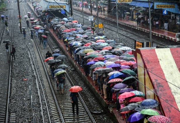 RECORD DATE NOT STATED Commuters Use Umbrellas Amid Heavy Rainfall at Kolkata Railway Station Kolkata West Bengal , Aug 17 (ANI): Commuters use umbrellas to shield themselves from rain while boarding local trains amid heavy rainfall at Bidhannagar Road railway station, in Kolkata on Monday. Kolkata West Bengal India Copyright: xANIx ANI_20260817148