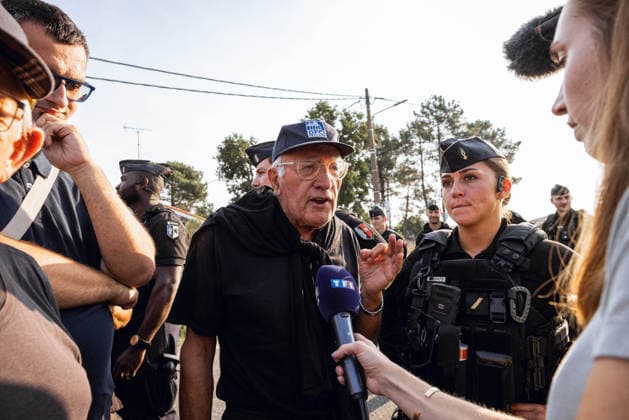 Lecornu Visits Fire-Hit Area As Residents Seek Aid - Le Porge French Prime Minister Sebastien Lecornu arrives at a gathering of wildfire victims dressed in black in Le Porge, Gironde, France on August 17, 2026, after the meeting location was moved from the town hall to the fire station where he was in discussion with local mayor Martial Zaninetti, while residents hoped for updates on aid measures before he departed without meeting them. A TF1 journalist interviews a resident. Photo by Gardelle M ANDBZ ABACAPRESS.COM Le Porge Nouvelle-Aquitaine France  Copyright: xANDBZ ABACAx