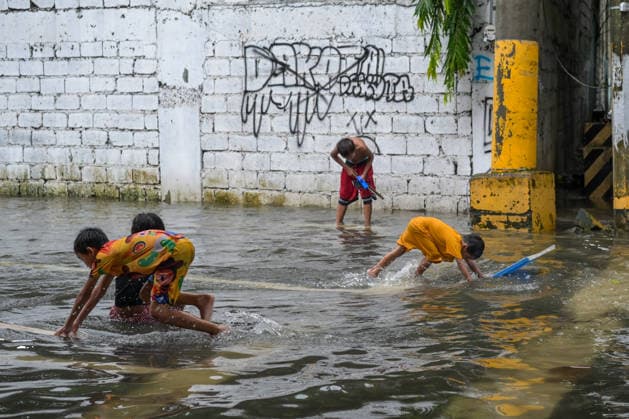 August 17, 2026, Philippines: Children playing in the flood water brought by torrential monsoon rains at Qurino Ave., Manila, Metro Manila. Two days ago, Metro Manila and neighboring provinces experienced a hot and humid weather. Monsoon rain came back yesterday and persisted throughout the day with flash floods in different areas of the metropolitan. Philippines  - ZUMAr240 20260817_zip_r240_060 Copyright: xMarcxDominicxRostratax