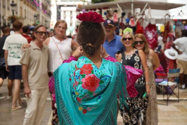 Scene at the 2026 Málaga Fair: Several women, dressed in traditional flamenco dresses, stroll through the Málaga Historic Center Fair. August 17, 2026, in Málaga, Andalusia, Spain. The capital of the Costa del Sol celebrates its big week, during which residents and visitors gather to enjoy the festive atmosphere and the numerous activities offered by the Feria. August 17, 2026, in Málaga, Andalusia, Spain Málaga, Andalusia, Spain Spain  Copyright: xÃlexxZeax 7718769