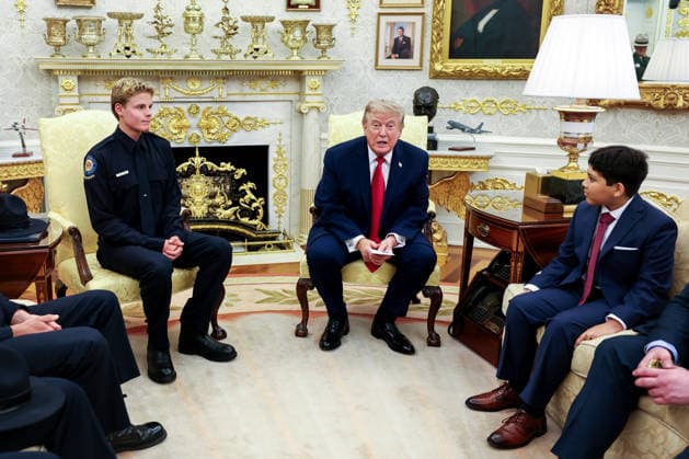 President Donald Trump hosts Lifeguard Ryder Williams (left) in the Oval Office of the White House in Washington, DC on August 17, 2026. Ryder Williams, a 16-year-old lifeguard, saved the life of 10-year-old Nathaniel Rai (right) at Seabright Beach in Santa Cruz, California on July 25.  WASP20260817100 SamuelxCorum